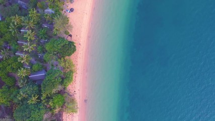 Wall Mural - Aerial view of Beach with shade emerald blue water and wave foam on tropical sea 