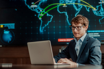  Young it engeneer business man with thin modern aluminium laptop in network server room