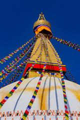 The top of the repaired Boudhanath stupa. An important religious site for Tibetan Buddhists, this colorful stupa is one of the most popular tourist sites in Kathmandu, Nepal.