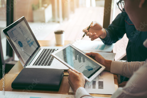 Fotografía Business partnership coworkers using a tablet to chart company financial statements report and profits work progress and planning in office room