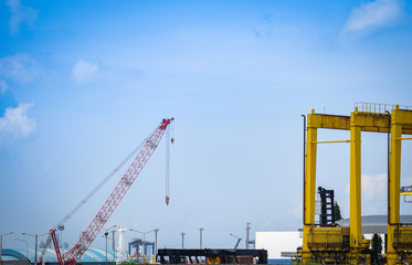 Wall Mural - Crane and container ship in export and import business and logistics in harbor industry