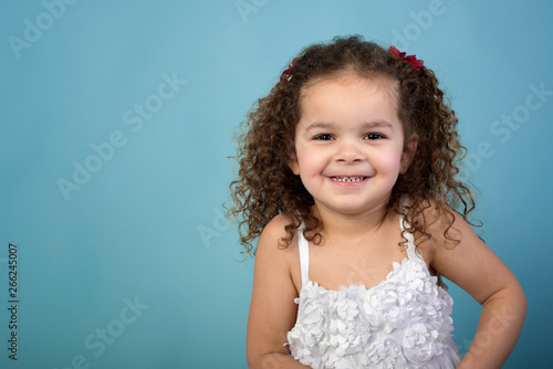 Adorable Smiling Mixed Race Toddler Girl With Curls Isolated On