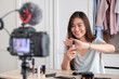 © weedezign - Asian young female blogger recording vlog video with makeup cosmetic at home online influencer on social media concept.live streaming viral