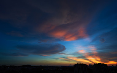 beautiful vibrant orange cloud and blue sunset sky .