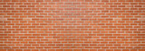 Red color brick wall for brickwork background design . Panorama format .