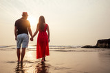 Fototapeta Sport - Young couple in love on the beach February 14, St. Valentine's Day sunset Goa India vacation trip .travel new year in a tropical country. freedom concept