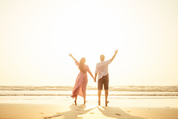 Young couple in love on the beach February 14, St. Valentine's Day sunset Goa India vacation trip .travel new year in a tropical country. freedom concept