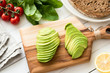 Sliced avocado on wooden cutting board, healthy cooking and healthy green lifestyle concept