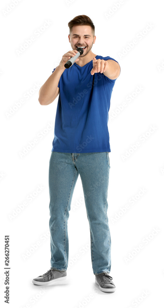 Handsome male singer with microphone on white background