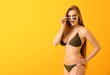 © Pixel-Shot - Beautiful young woman in swimsuit on color background