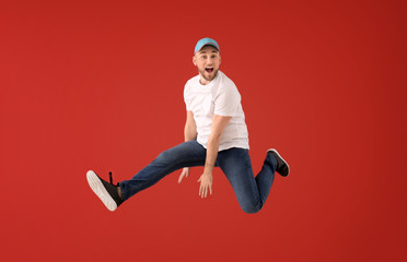 Sticker - Jumping young man on color background