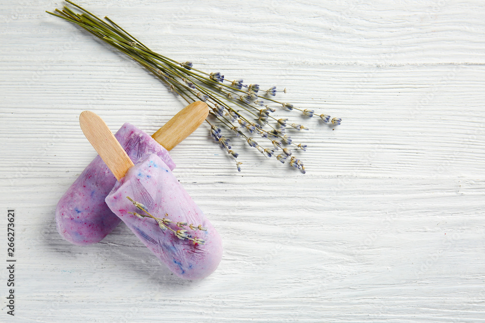 Tasty lavender ice cream on white wooden background