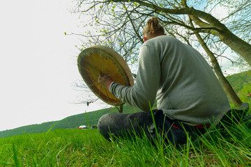 man playing a shaman tambourine