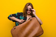 © Asier - Young woman holding a leather bag  scared about her vacations, she has fobia to fly.
