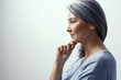 © Svyatoslav Lypynskyy - Beautiful Asian with white hair smiling standing near the wall