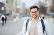© bnenin - Portrait of a smiling student at the city street.