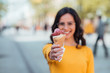 © bnenin - Vacation concept.Young woman offering ice cream toward camera, focus on ice cream.