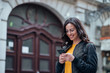© bnenin - Happy female student texting on smart phone in the city.