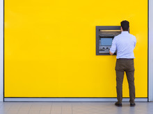 Man Withdrawing Money From An Atm Bank Machine