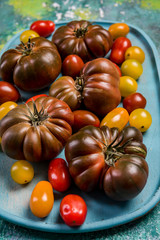 Wall Mural - Colorful tomato variety on wooden board