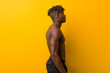 © Asier - Young black man shirtless wearing swimsuit gazing left, sideways pose.