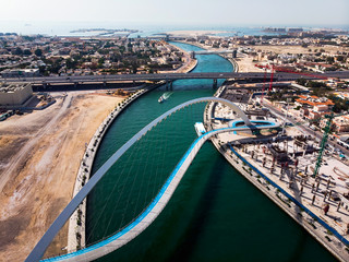 Wall Mural - Dubai water canal tolerance bridge over the creek aerial