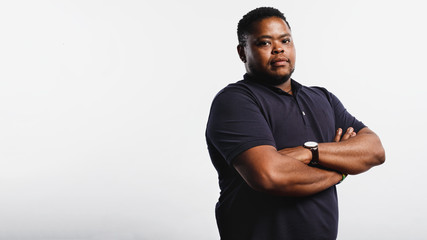 african man standing with arms crossed