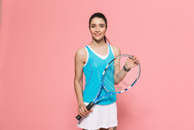 Beautiful Young Pretty Fitness Woman Holding Tennis Racket Posing Isolated Over Pink Wall Background.