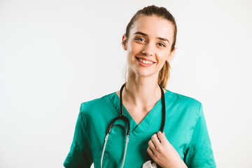 Cheerful female doctor in green uniform.