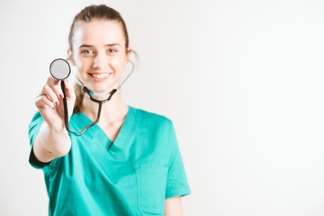 Wall Mural - Cheerful female doctor in green uniform.