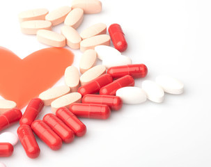 medical red and white pills and capsules with medicine are on a white background