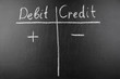 © Александр Бердюгин - Double-entry bookkeeping, debit and credit on black chalkboard
