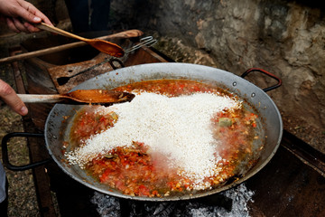 Wall Mural - man preparing a typical spanish paella