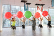 © RomanR - Group of people in gym smiling with a pilates ball