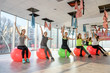 © RomanR - Group of women in gym making exercises on ball