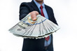 © RomanR - Man in suit offering dollar banknotes close up