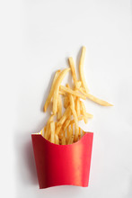 French Fries In A Carton Box Or Red Paper Pouch Isolated With White Background