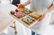 © Criene Images - Woman carying wooden board with healthy sandwiches