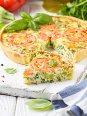 Wall Mural - Quiche with vegetables (squash, tomatoes, cheese, herbs, green onions), open tart, French cuisine, traditional pastries