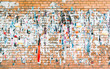 Brick wall with the remains of old advertisements and posters