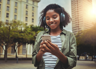 Wall Mural - Young woman watching video using mobile phone