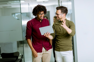 Multiethnic business partners using a digital tablet in the office