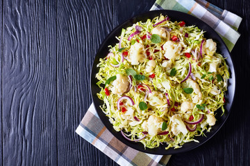 Wall Mural - cauliflower salad with spring cabbage, top view