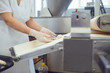 © Studio Romantic - The hands of a woman working on the equipment make the dough for bread