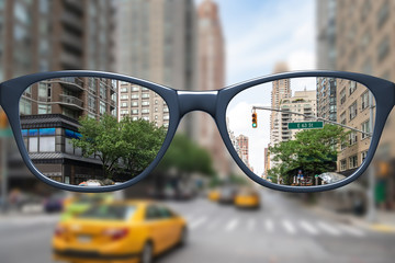 glasses with sharp and blurred big city