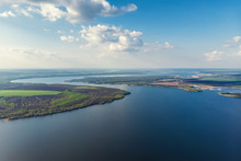 Scenic Aerial Panoramic Landscape Of Oskol River Curve In Eastern Europe With Green Forest At Banks And Blue Cloudy Sky. Natural Scenic Summer Travel Panorama Wallpaper. Aerial Drone Shot