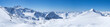 Panoramic landscape view from top of Schaufelspitze on winter landscape with snow covered mountain slopes and pistes at Stubai Gletscher ski resort at spring sunny day. Blue sky background. Stubaital