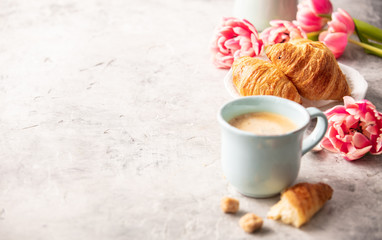 Wall Mural - Morning coffee, croissants and spring tulips on light grey backg