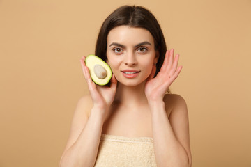 Wall Mural - Close up brunette half naked woman 20s with perfect skin nude make up hold avocado isolated on beige pastel wall background studio portrait. Healthcare cosmetic procedures concept. Mock up copy space.