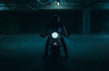 Silhouetted Cafe Racer Motorcycle In A Parking Garage